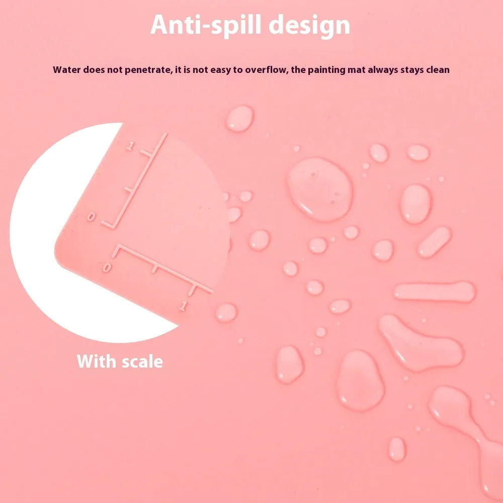 Light blue silicone painting mat measuring 50 by 40 centimetres on a wooden table.