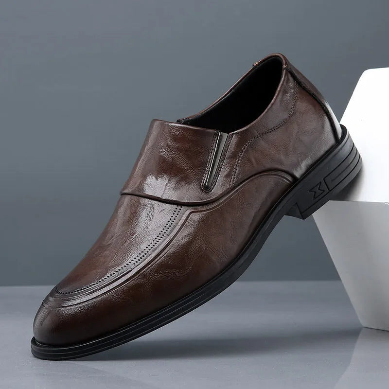 Men's black cowhide leather slip-on casual shoes with rubber sole on a plain background