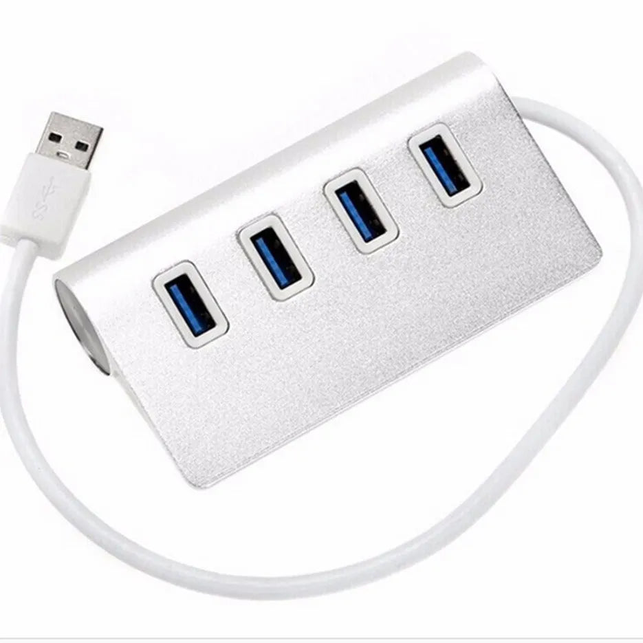 Silver aluminium alloy four-port USB 3.0 hub on a desk with cables connected, 98x58x30mm