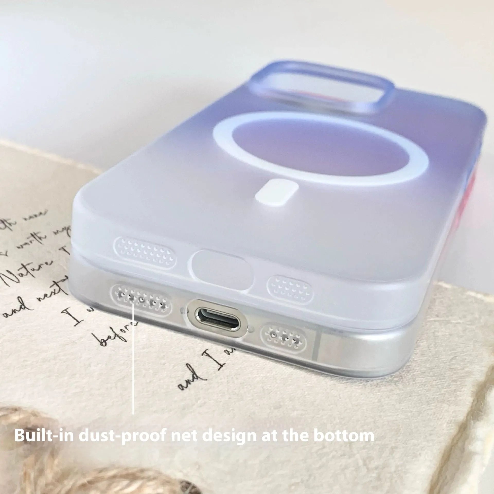 Gradient frosted blue magnetic suction protective case for iPhone on a table.