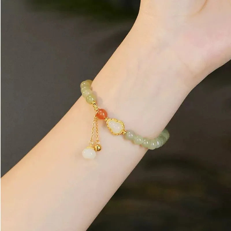 Jade women's bracelet with gold-plated gourd charm and fu character traditional design elements