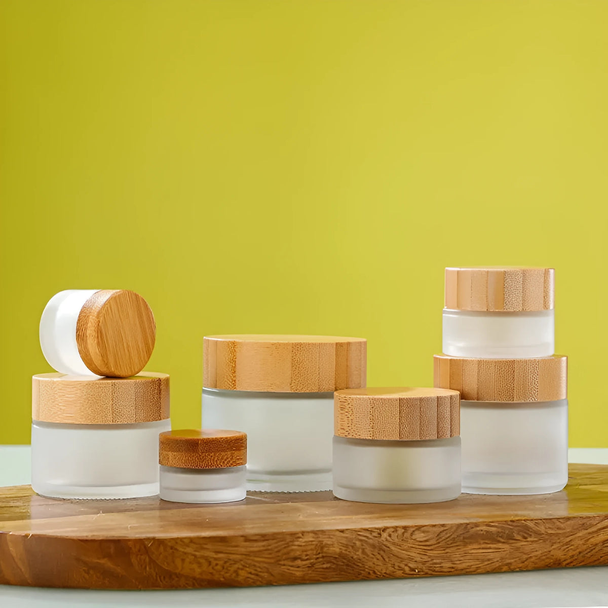 Glass cream jar with bamboo wood lid in frosted finish for facial skincare storage