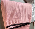 Pure colour seersucker cooling quilt laid flat, showing quilted texture and simple edging.