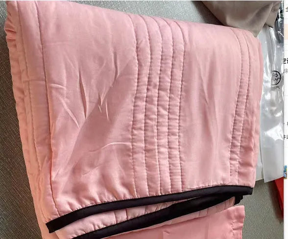 Pure colour seersucker cooling quilt laid flat, showing quilted texture and simple edging.
