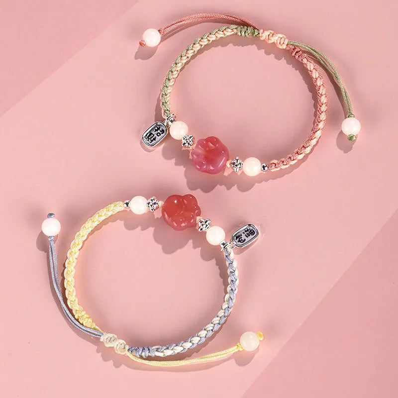 Red glass cat's paw charm bracelet with woven cord in pink or yellow for couples