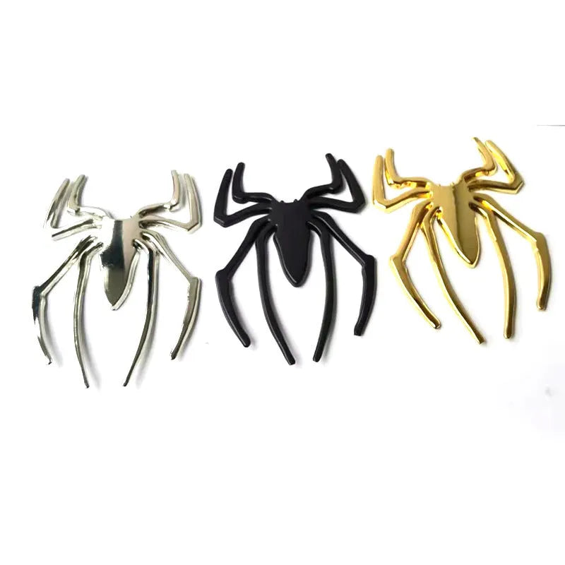 Three-dimensional metal spider bumper sticker in metallic finish measuring 7cm by 5cm