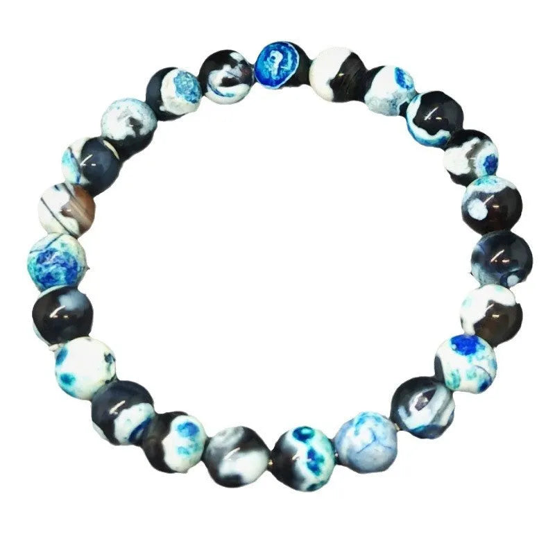 Close-up of a bohemian-style bracelet with 8mm natural agate beads and glass accents on a wrist.