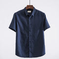 Men's light blue linen short sleeve shirt with a square collar on a hanger.