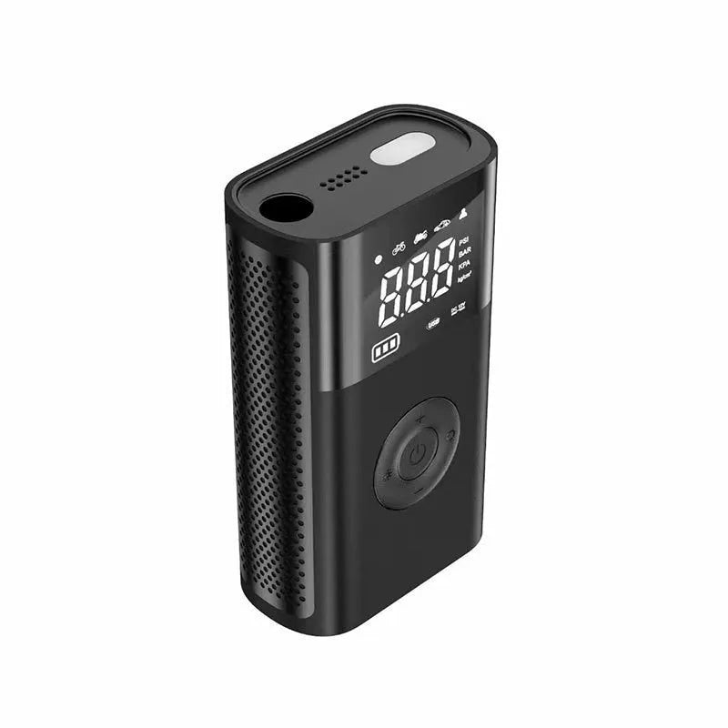 Black handheld wireless digital tyre inflator with LCD screen, LED light and multiple nozzle attachments on a table.