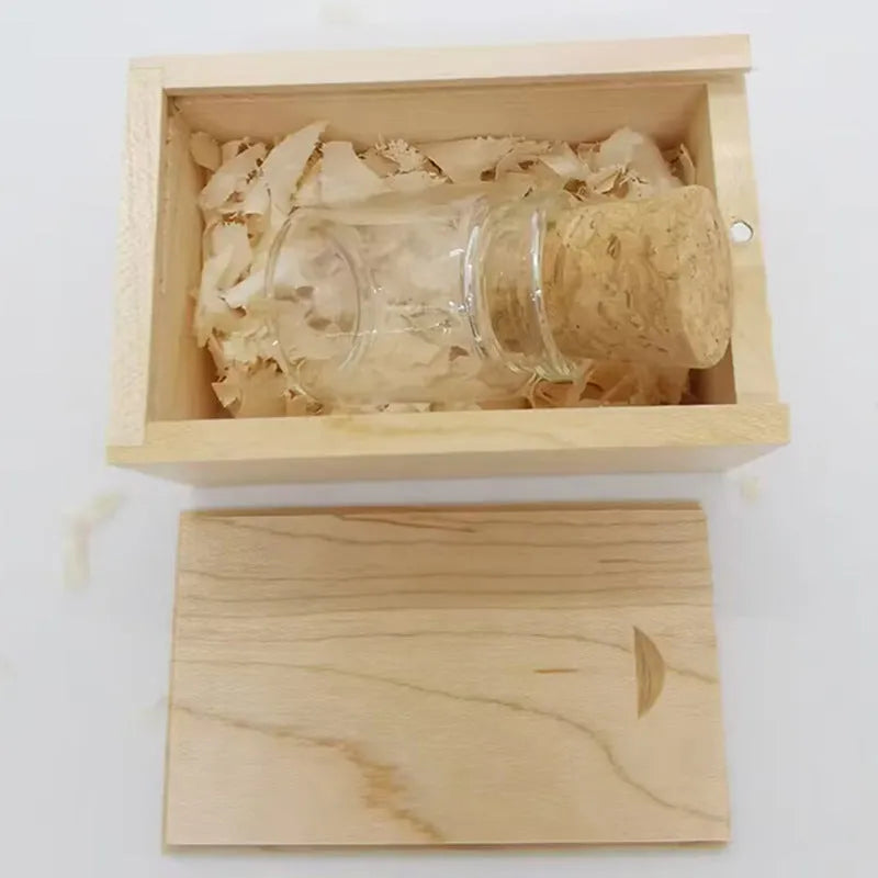 Wooden-lidded transparent glass bottle-shaped USB flash drive on a white background.