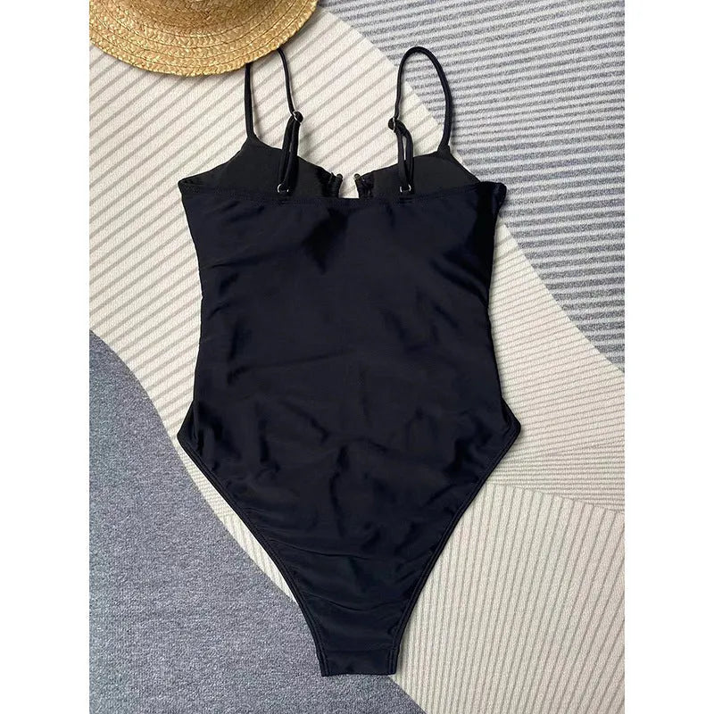 Women's black solid colour one-piece swimsuit with figure-hugging design on mannequin