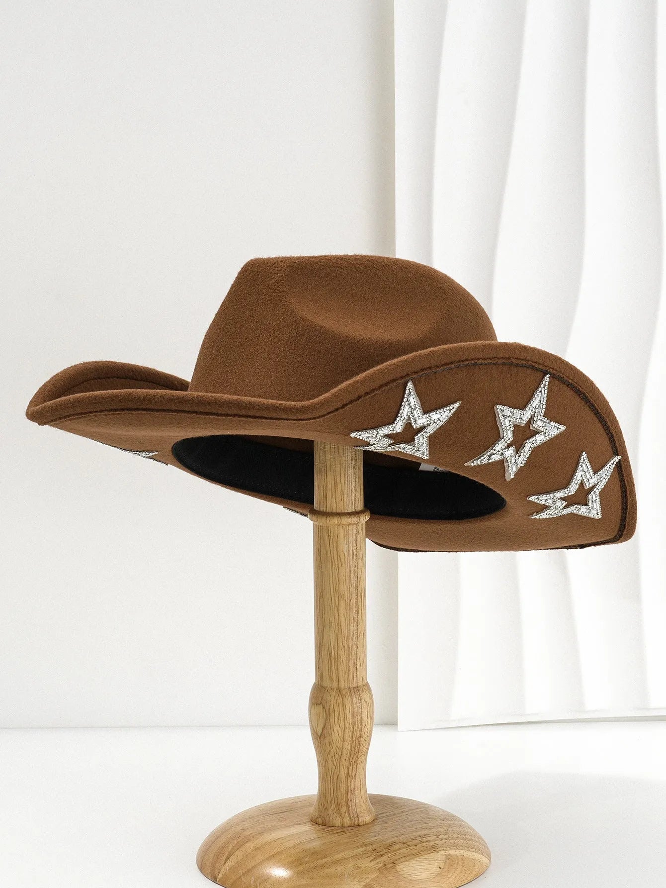 A beige polyester western denim top hat with a conical crown and a woven hexagonal star design on the front.