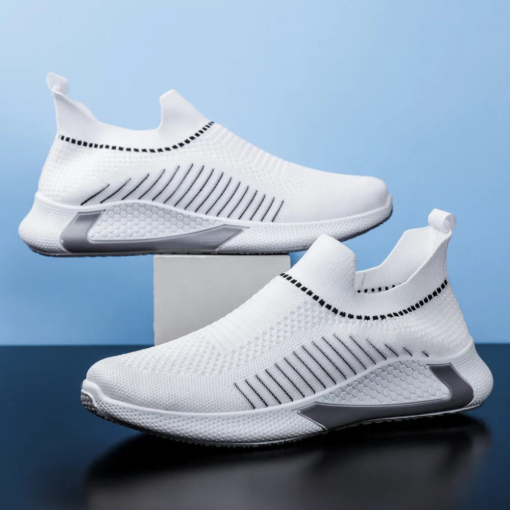 Men's black and white striped mesh slip-on sneakers with flyknit upper and low-cut profile.