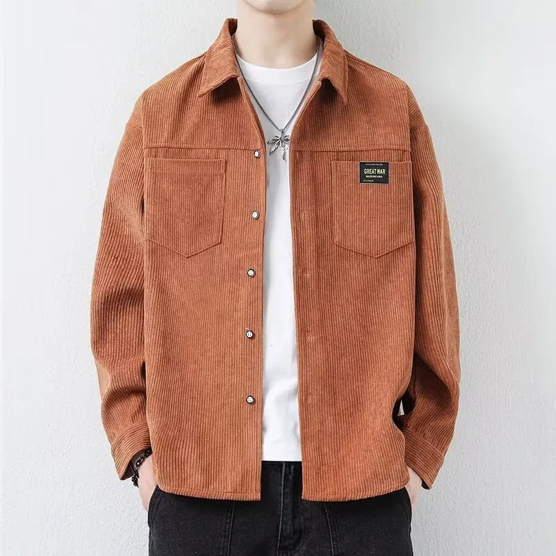 Man wearing a dark grey corduroy cardigan-style jacket with long sleeves.
