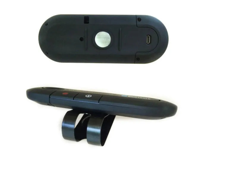 Black car Bluetooth handsfree kit clipped to a sun visor, showing the speaker grille and included car charger.