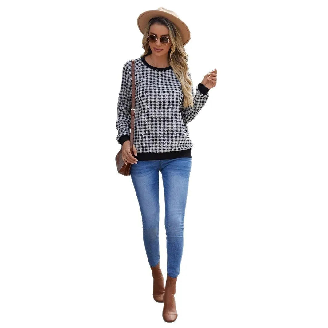 Black long sleeve polyester sweater with a plaid pattern, shown on a hanger.