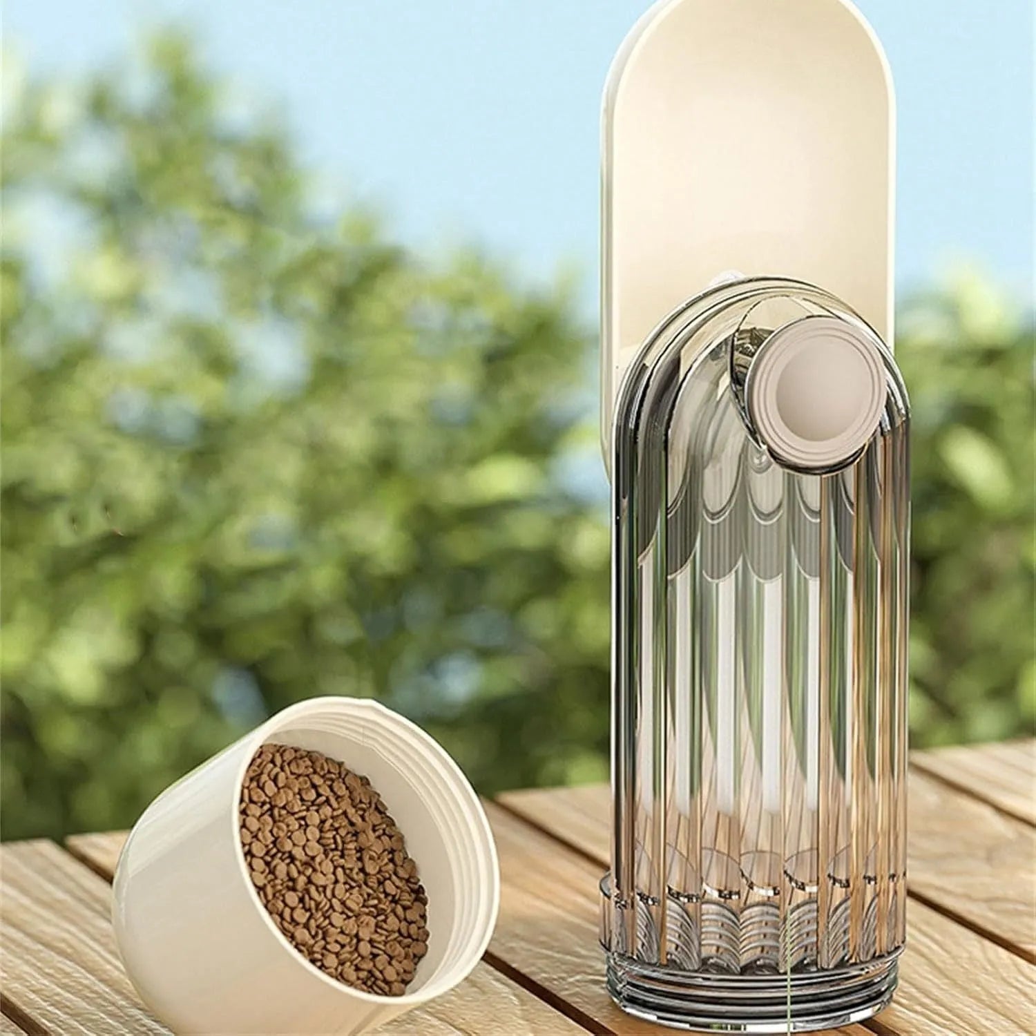 Beige foldable dog water bottle and food dispenser with press mechanism, shown next to a green version.