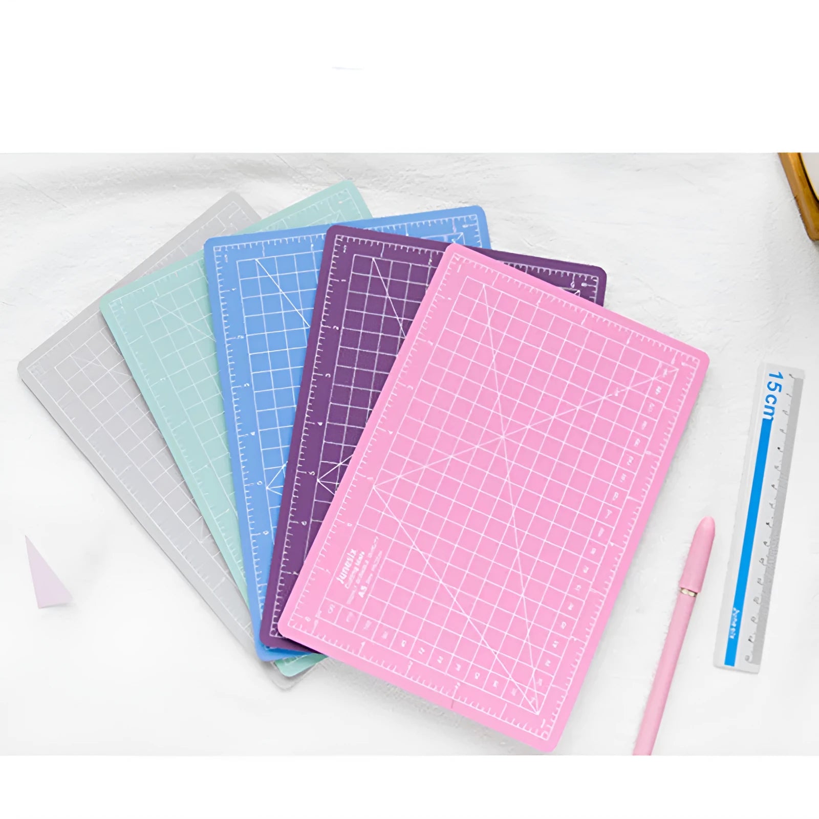 Art pen knife cutting board set in blue, showing plastic backing board with ruler, metal blade, and sharpener.