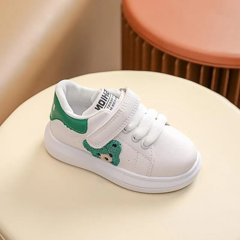 Baby Bear cartoon pattern children's sneakers in green, shown on a white background.