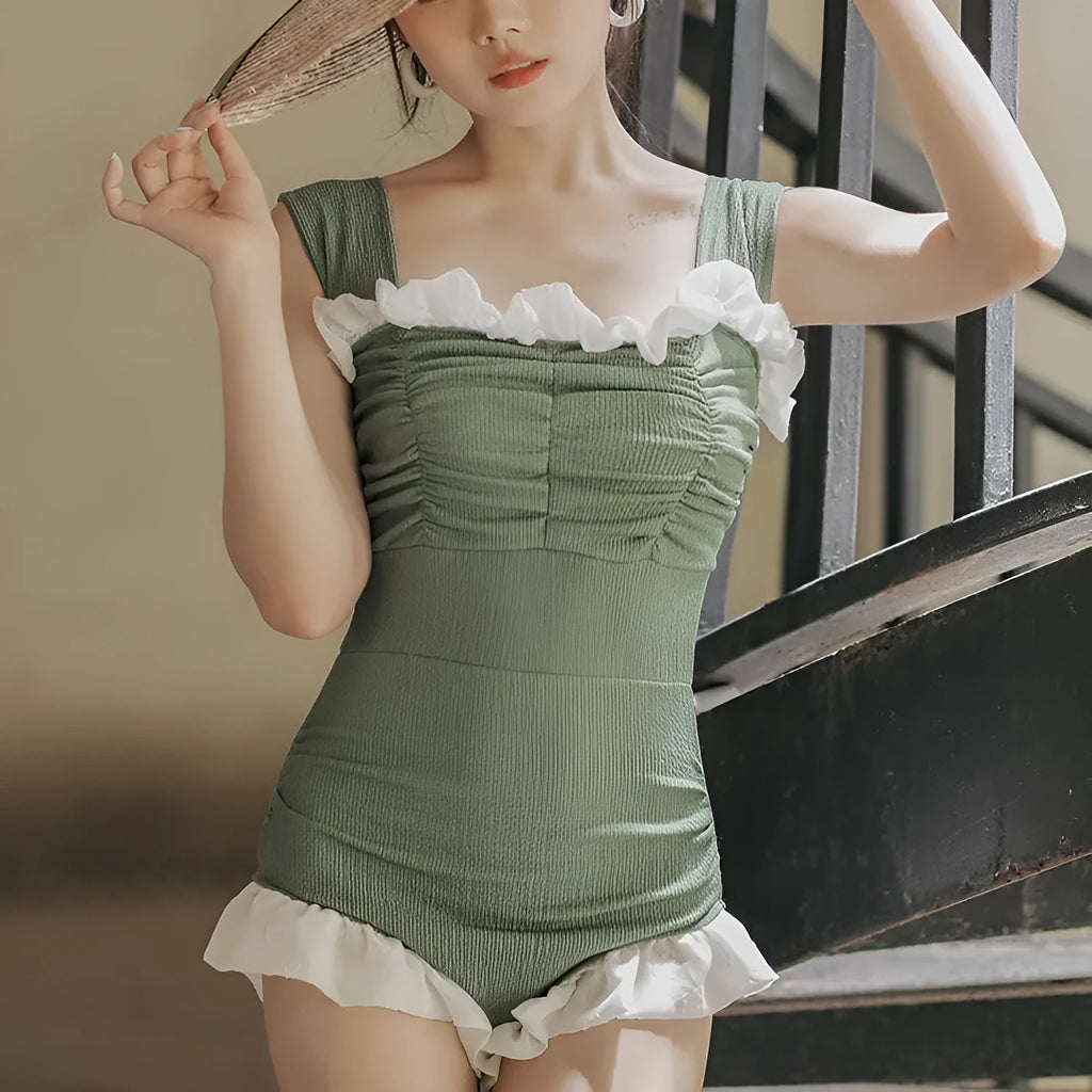 Women's black high-waisted one-piece triangle swimsuit, Korean style, on a mannequin.