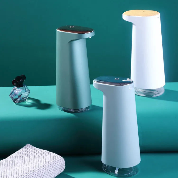 White automatic foam soap dispenser with sensor for touch-free operation on bathroom counter