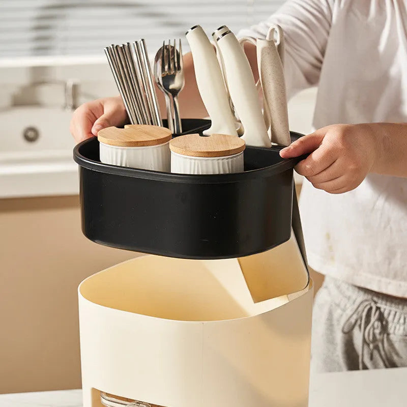 White rotating kitchen storage bucket with separate four-section spice box organiser on countertop.