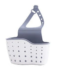 Three plastic kitchen sink storage racks in beige light blue and light pink on a draining board