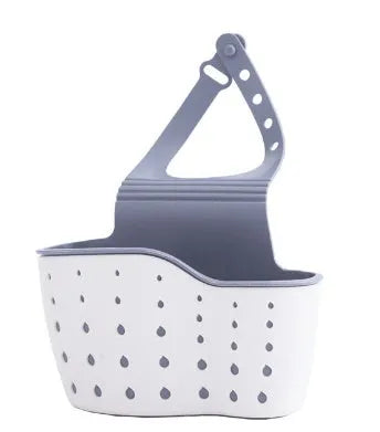Three plastic kitchen sink storage racks in beige light blue and light pink on a draining board