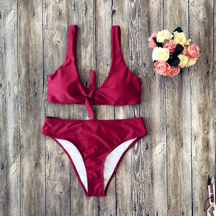 Women's solid colour bikini set with bra top and briefs in black, pink, red, white, or wine red.