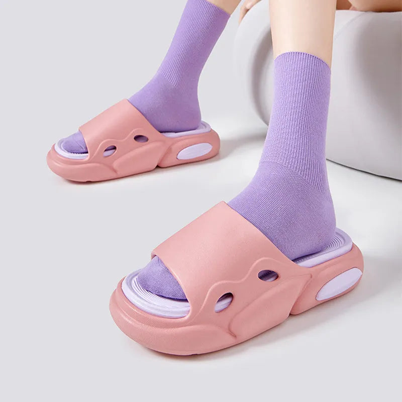 Two-colour EVA slippers showing black and white design with thick sole and leather lining
