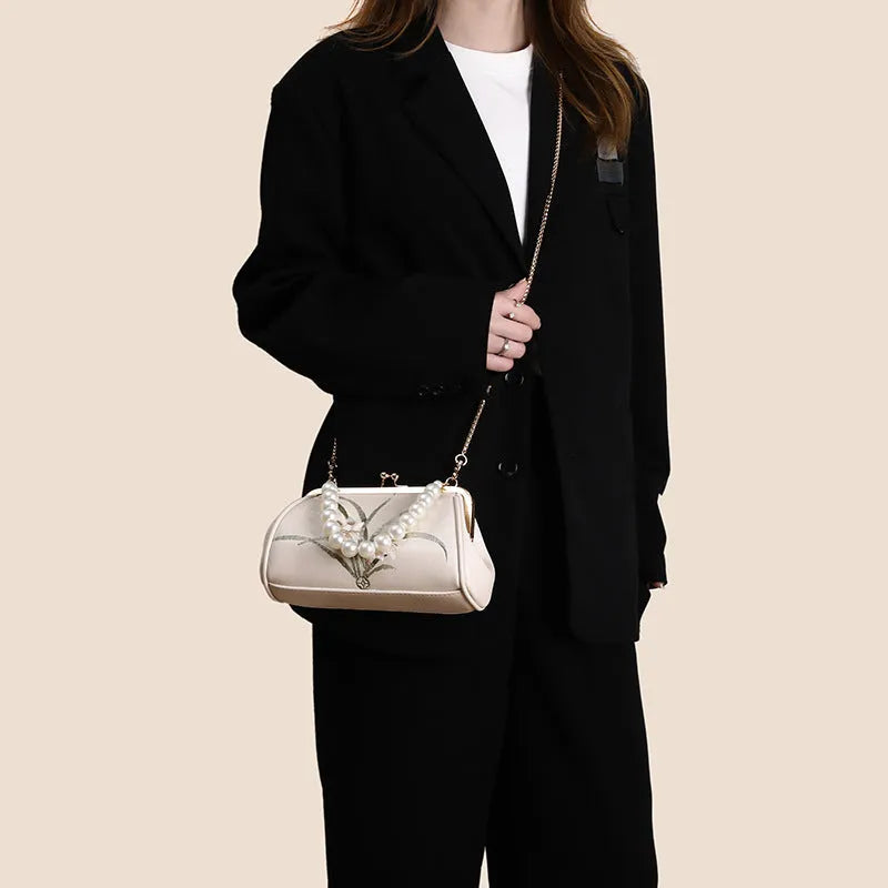 Beige women's embroidered shoulder bag in soft PU leather with shell-shaped design