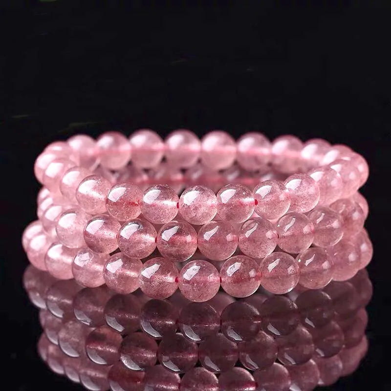 Women's strawberry quartz crystal bracelet with polished beads in 6mm, 8mm, or 10mm sizes.