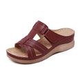 Women's red peep toe wedge sandals with a Velcro strap fastener on a white background.