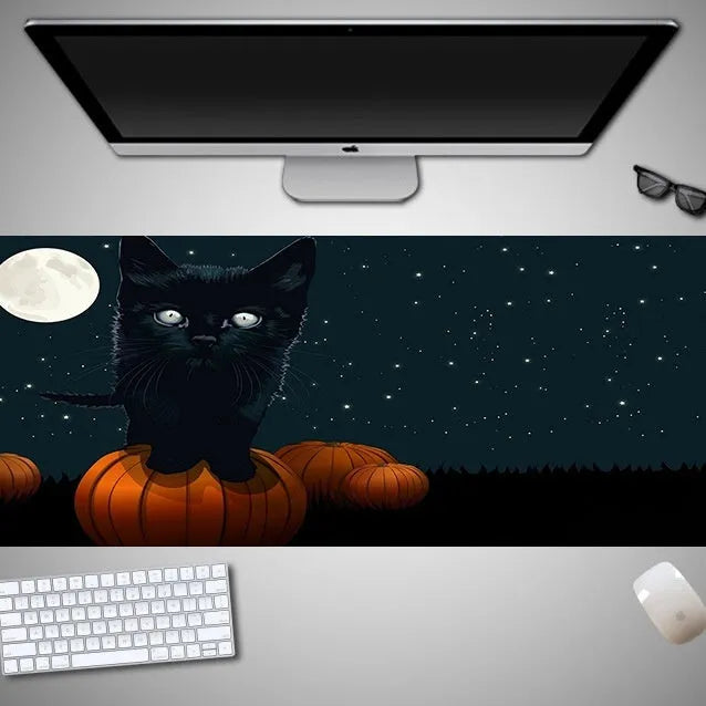 Oversized Halloween-themed gaming mouse pad with non-slip rubber base on a desktop