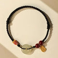 Hetian Jade peace buckle bracelet with koi fish charm on braided rope