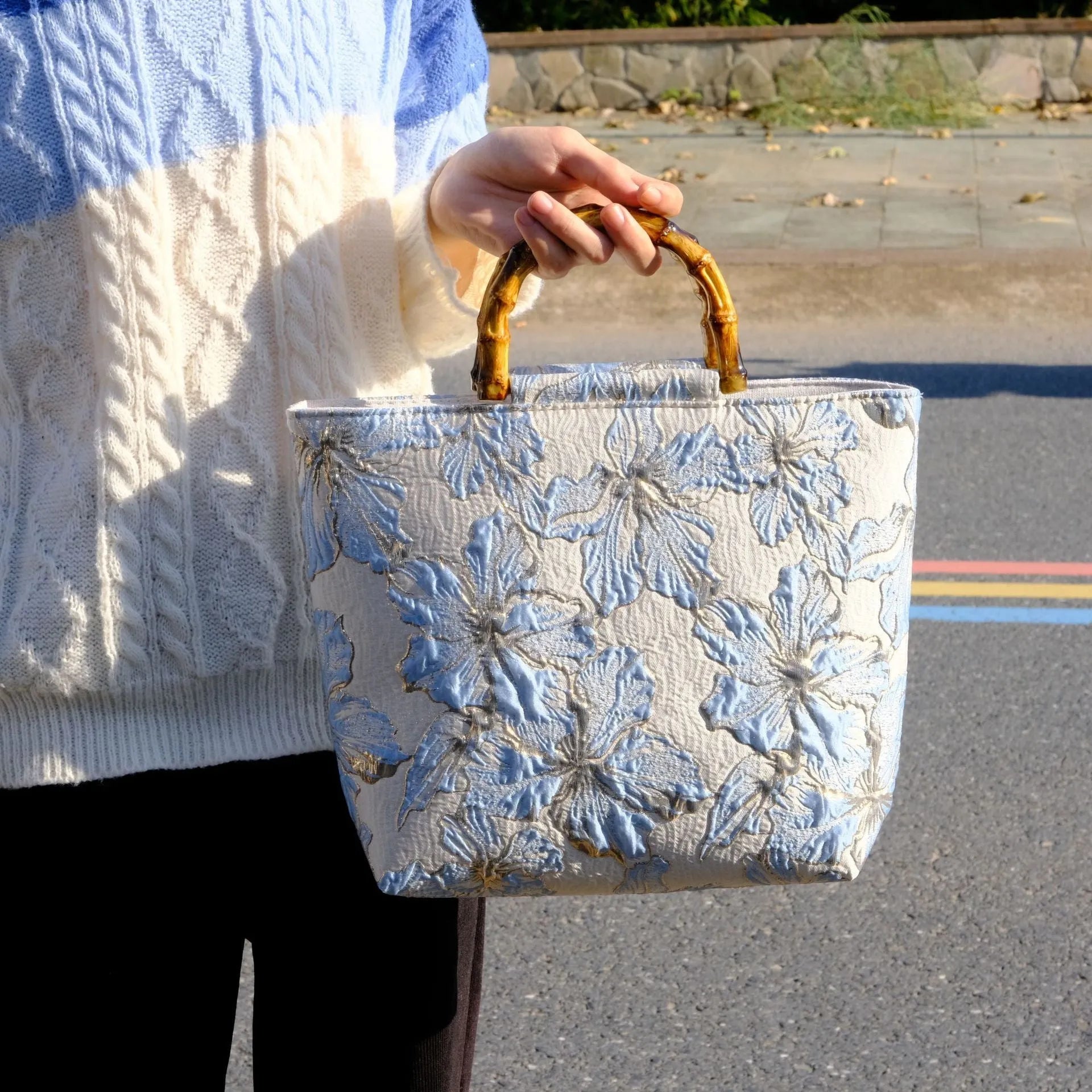 Light blue canvas shoulder bag with gold floral decoration and double shoulder straps