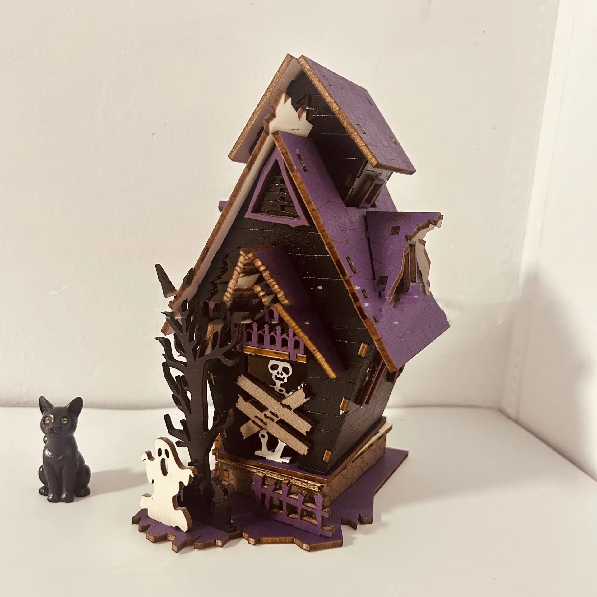 DIY wooden glowing haunted house Halloween table decoration and candlestick holder.