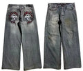 Gray washed-out denim jeans on a man, showing straight wide-leg cut and vintage workwear style.