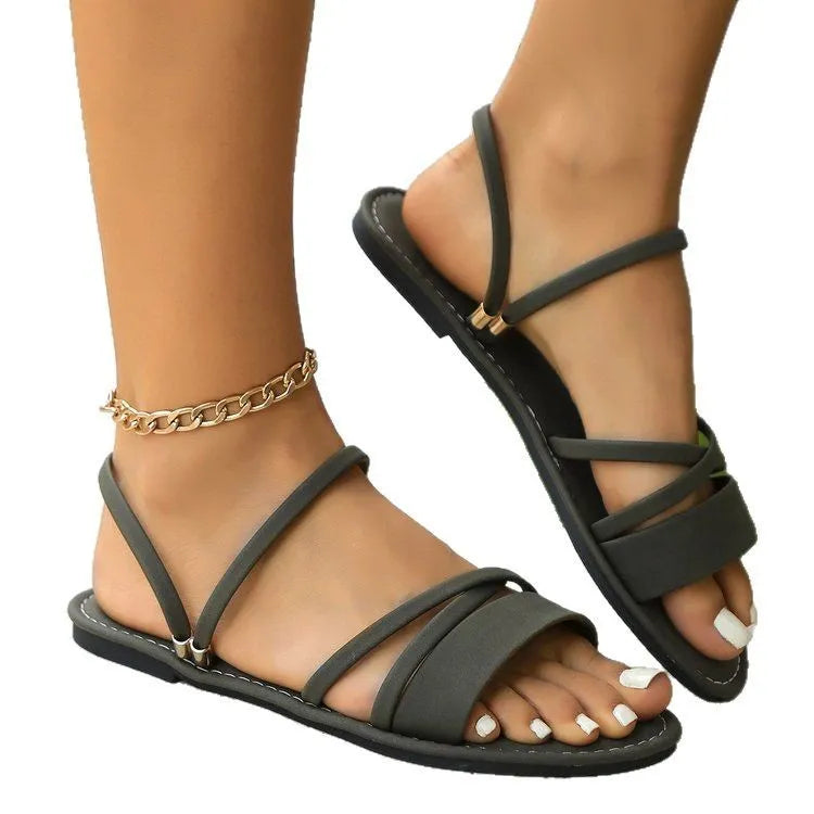 Women's plus size sandals with cross straps and flip-toe buckle in black, brown, or green colours