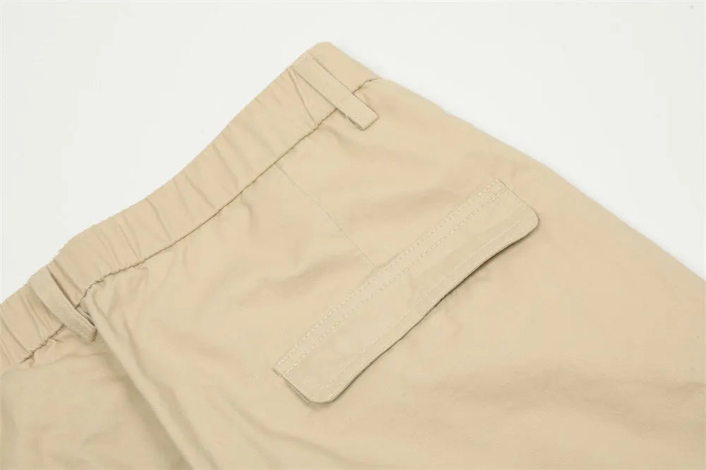 Men's solid colour cotton casual trousers in khaki, full-length view on display