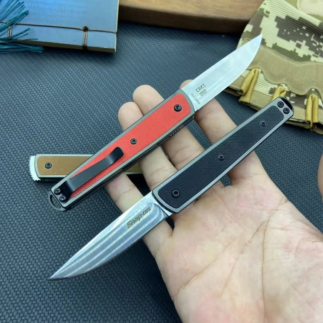 Folding fruit knife with stainless steel blade shown in black, brown, and red colour options