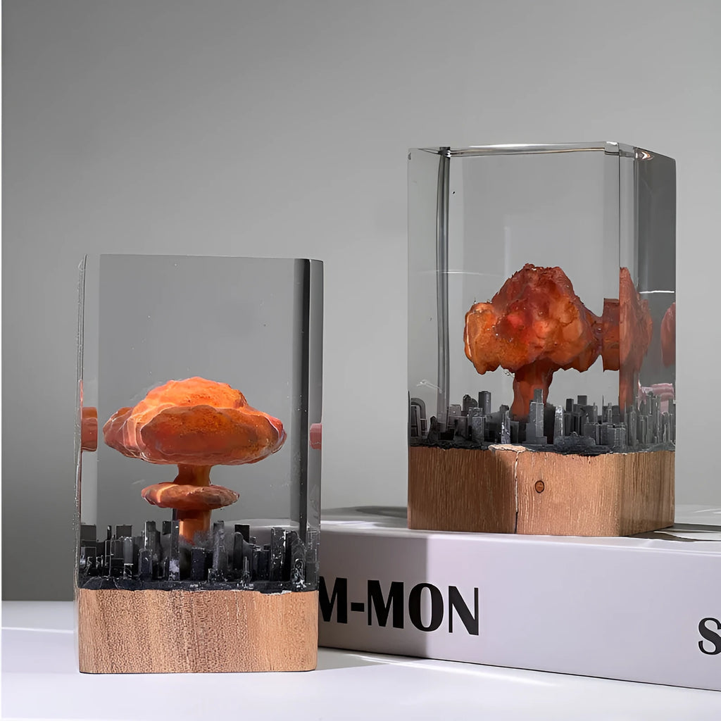 Small atomic bomb mushroom cloud shaped resin night lamp decoration in two colour variants on a dark surface.