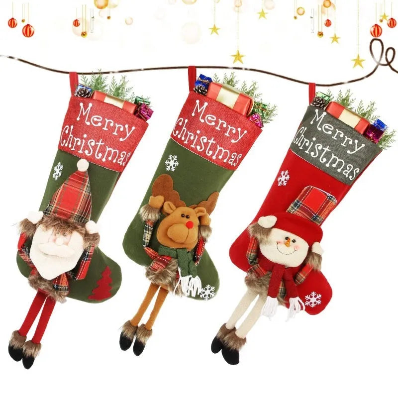 Three large Christmas stockings with 3D Santa, snowman, and reindeer designs hung on tree