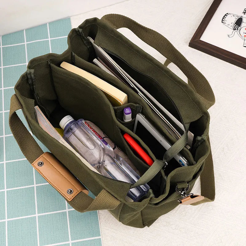 Canvas tote bag with multiple internal pockets including computer pocket, shown in horizontal square shape