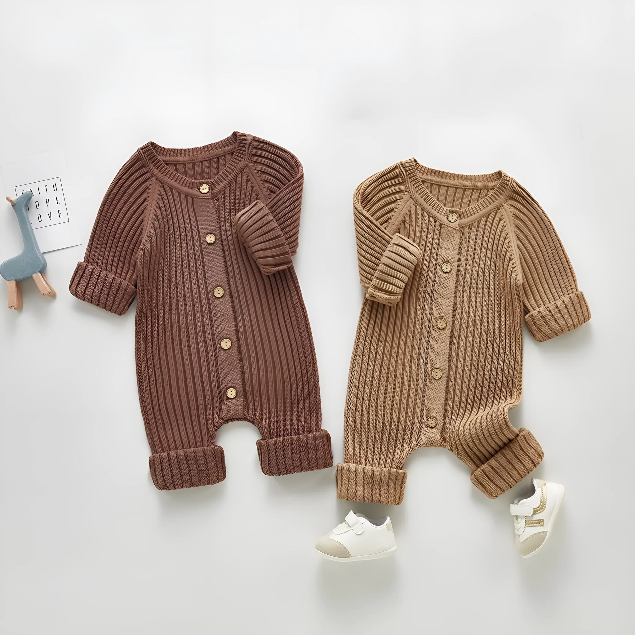 Baby long-sleeved knitted jumpsuit romper pullover in beige, size 80cm, lying flat on a white background
