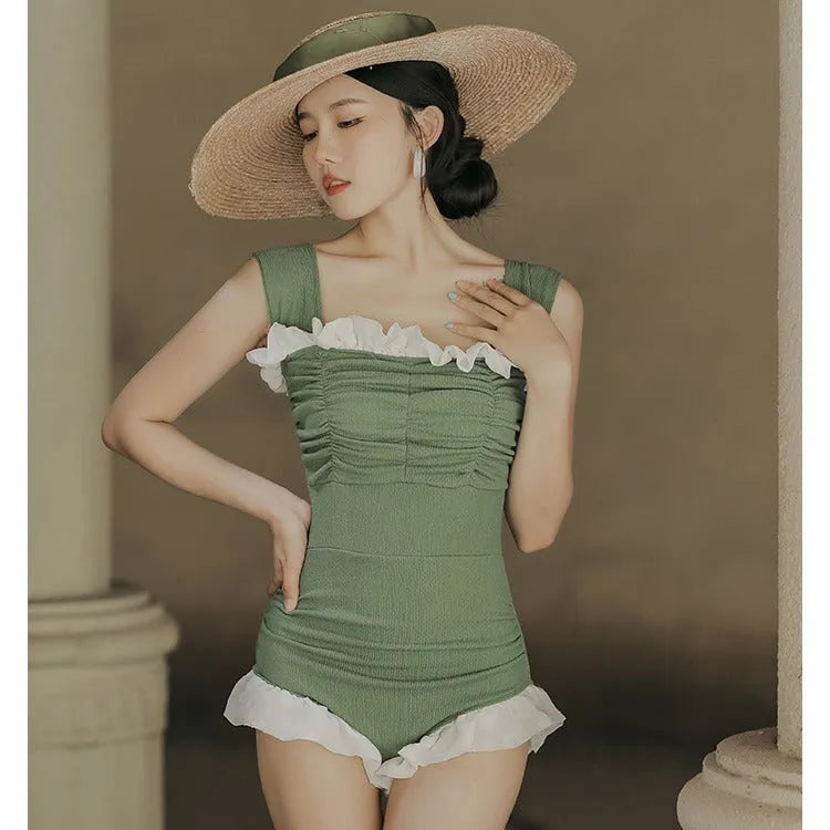 Women's black high-waisted one-piece triangle swimsuit, Korean style, on a mannequin.