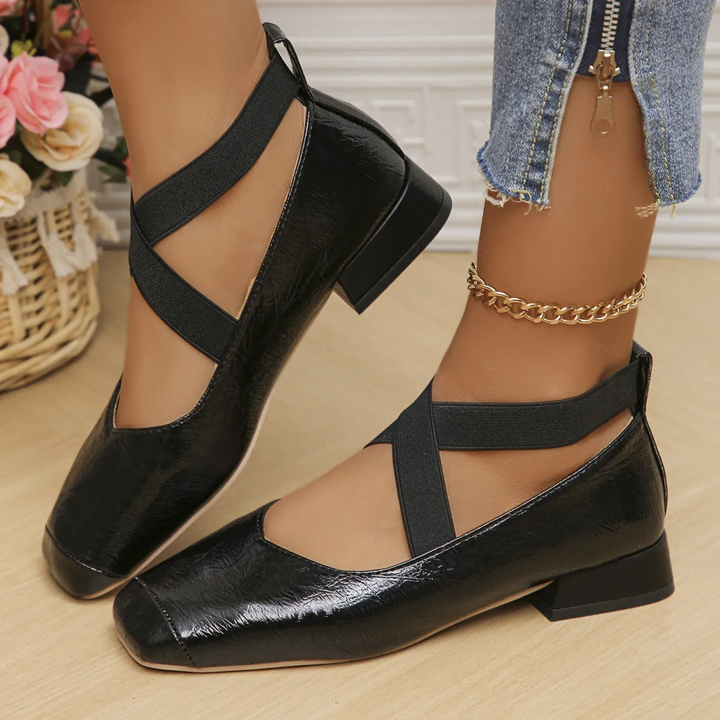Gold French evening style slip-on pumps with a skirted collar and square toe on a white background.