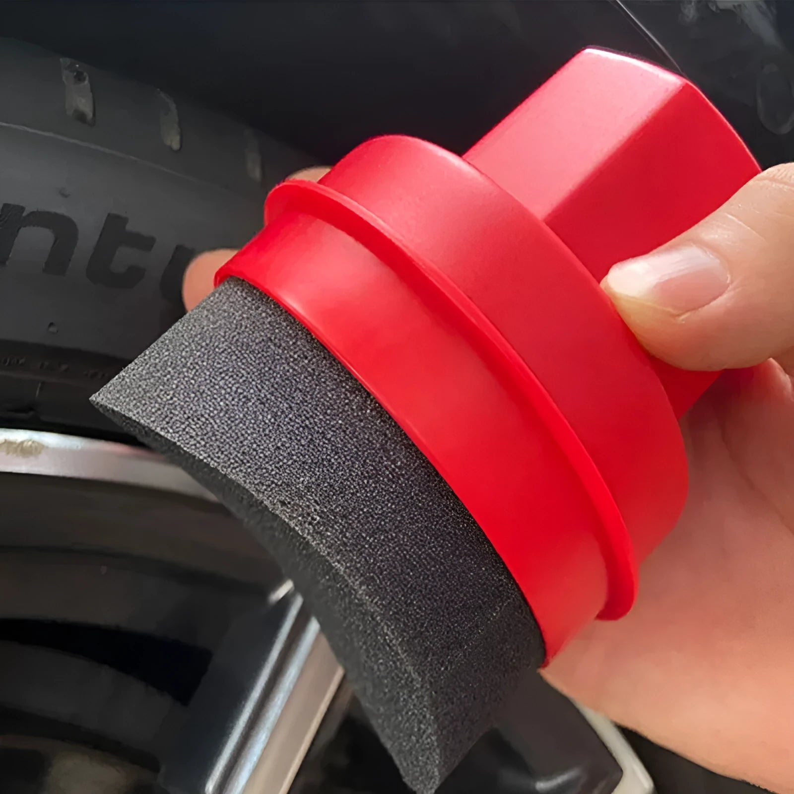 Black and red car tyre polishing sponge brushes with lids on a white background.