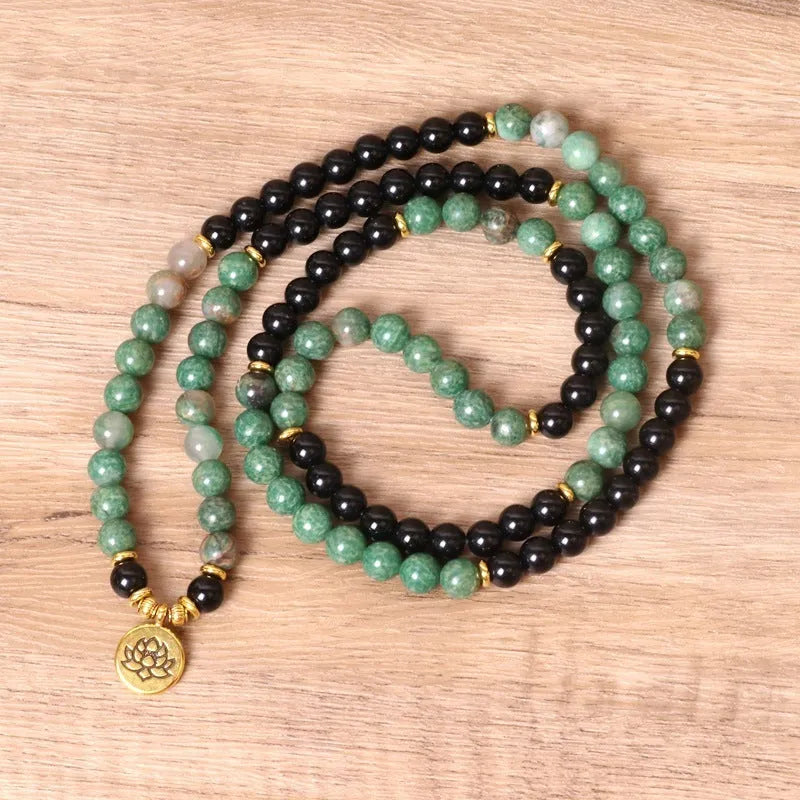 Green and black elastic beaded bracelet with alloy construction