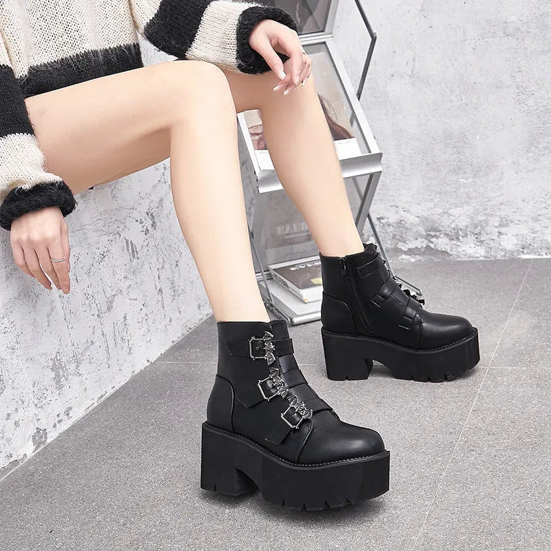 Black women's punk gothic Martin boots with bat buckle detail and side zipper.